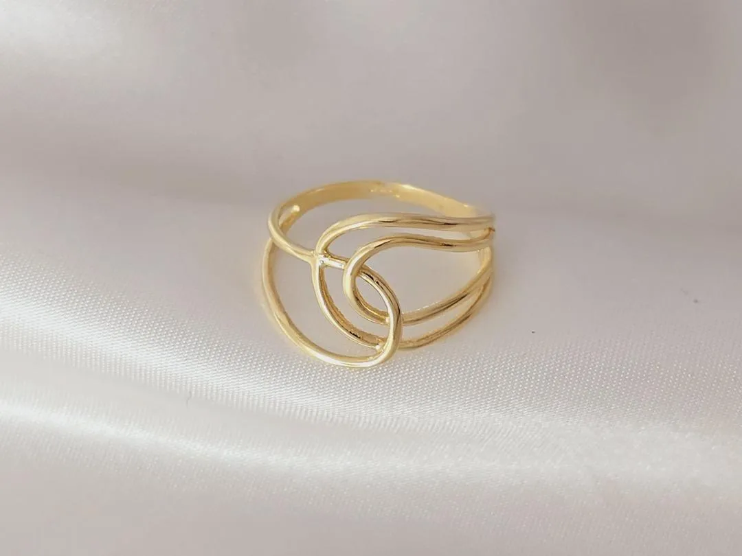 Anel com geometrico arredondado vazado banhado a ouro, medindo 1,8cm de espessura.